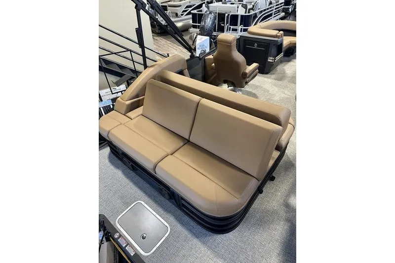 Slide: The Image of 2026 Bennington M Swingback 22 MSB boat interior with tan seating and modern design. - 19