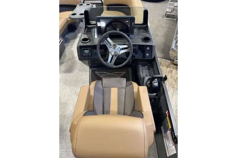 Slide: The Image of 2026 Bennington M Swingback 22 MSB boat helm with tan seating and modern controls. - 22