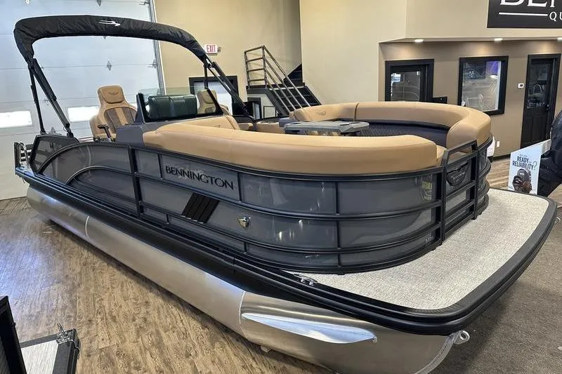 Slide: The Image of 2026 Bennington M Swingback 22 MSB pontoon boat displayed indoors, featuring luxurious seating. - 4