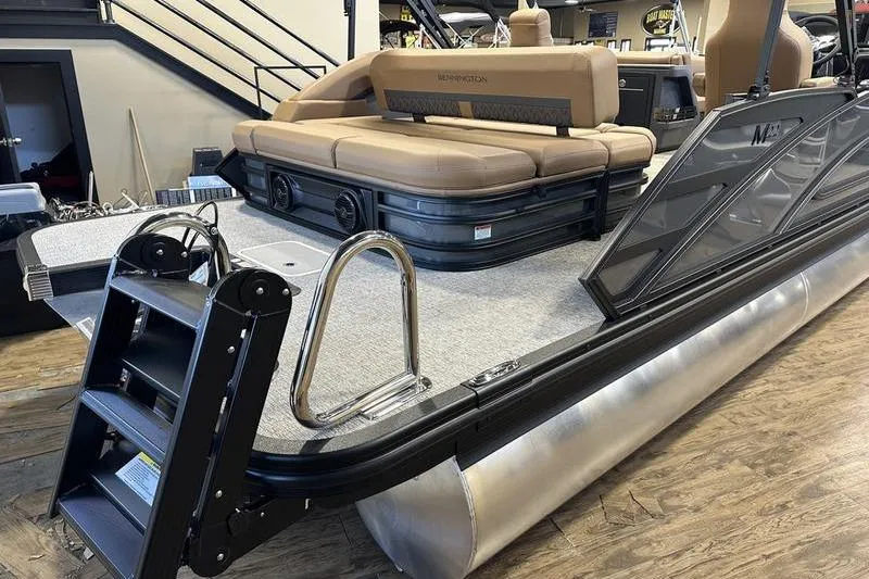 Slide: The Image of 2026 Bennington M Swingback 22 MSB pontoon boat with tan seating and swim ladder. - 6