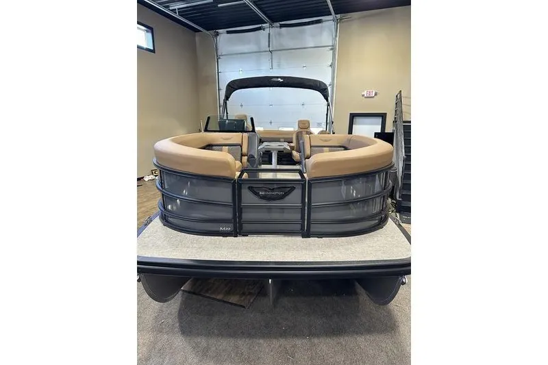 Slide: The Image of 2026 Bennington M Swingback 22 MSB pontoon boat with tan seating in a showroom. - 7