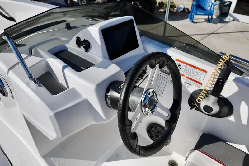 Slide: The Image of 2024 Tahoe T18 boat dashboard with steering wheel and control panel. - 10