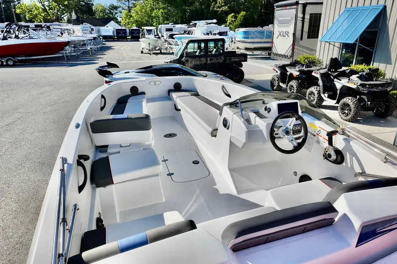 Slide: The Image of 2024 Tahoe T18 boat interior with modern seating and steering, displayed at a dealership. - 5