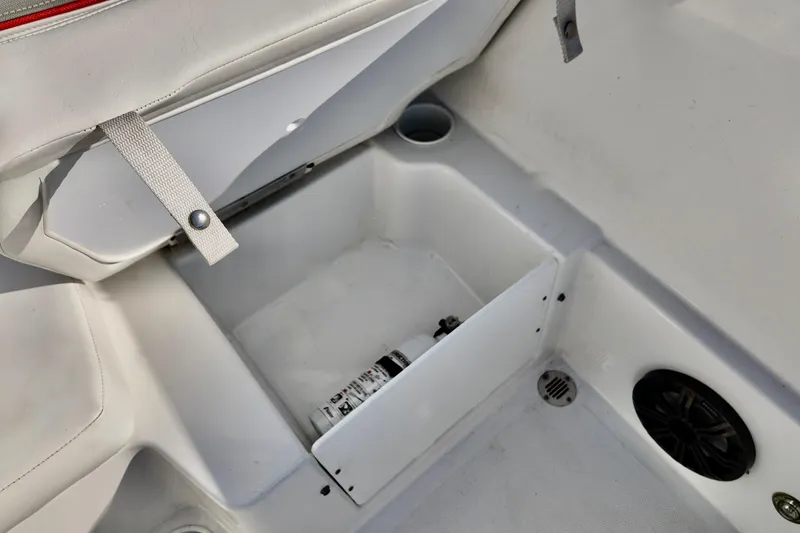 Slide: The Image of 2024 Tahoe T18 boat interior storage compartment with fire extinguisher and speaker. - 7