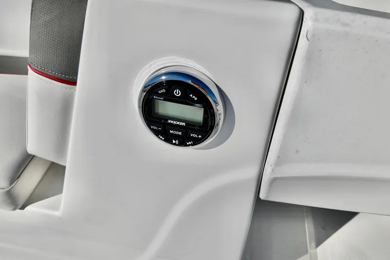 Slide: The Image of 2024 Tahoe T18 boat audio control panel with Kicker stereo system. - 9