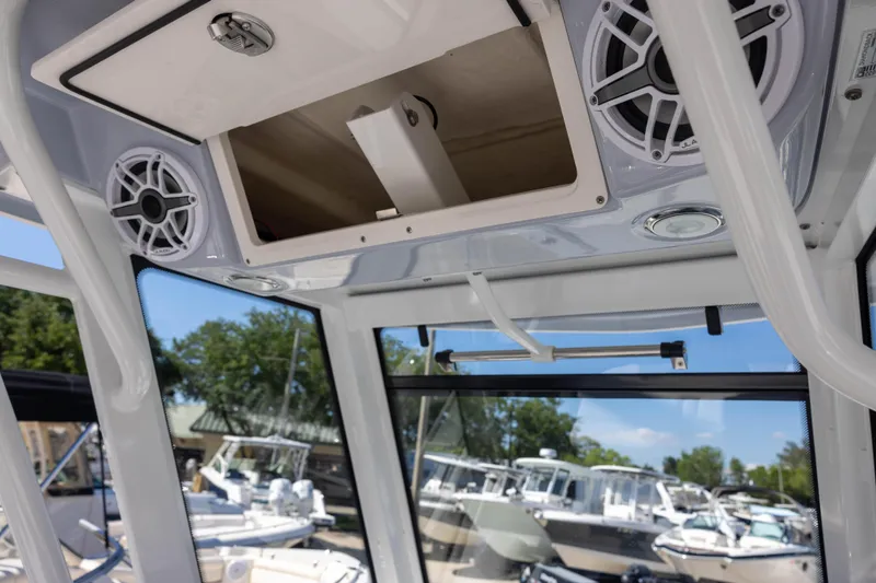Slide: The Image of 2023 Robalo 266 Cayman boat interior with speakers and storage compartment. - 11