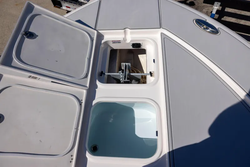 Slide: The Image of 2023 Robalo 266 Cayman boat storage compartments and anchor locker. - 15