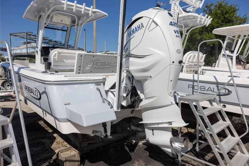 Slide: The Image of 2023 Robalo 266 Cayman boat with Yamaha 425 engine, docked and ready for use. - 2