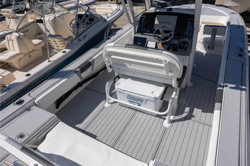 Slide: The Image of 2023 Robalo 266 Cayman boat interior with helm, seating, and Garmin navigation system. - 3