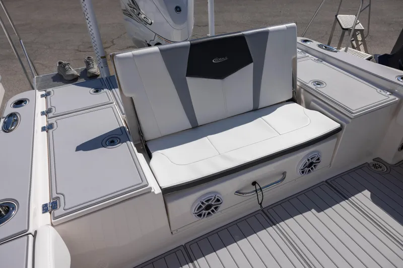 Slide: The Image of 2023 Robalo 266 Cayman boat seating area with storage and speakers. - 4