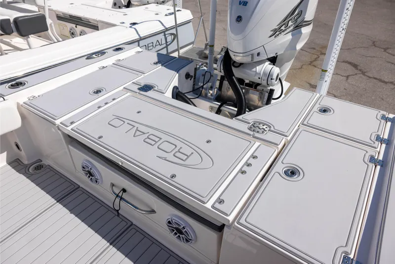 Slide: The Image of 2023 Robalo 266 Cayman boat deck with Yamaha V8 engine and storage compartments. - 5