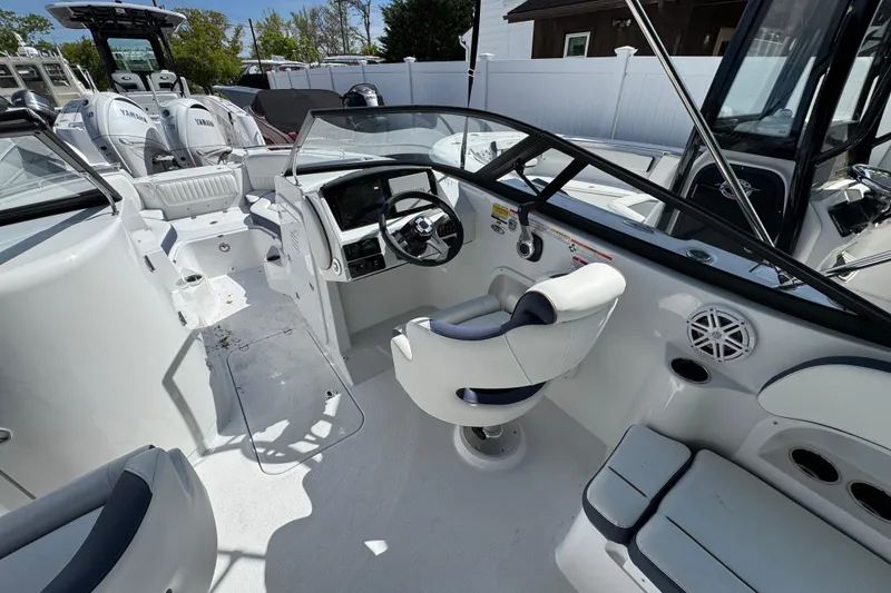 Slide: The Image of 2026 Stingray 211 DC boat interior with modern helm, seating, and Yamaha engines. - 11