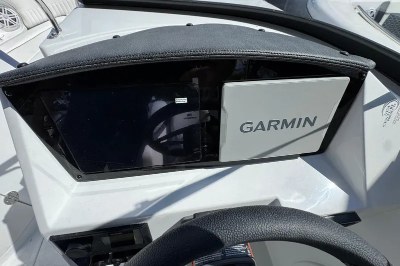Slide: The Image of Dashboard of 2026 Stingray 211 DC boat featuring Garmin navigation system. - 13