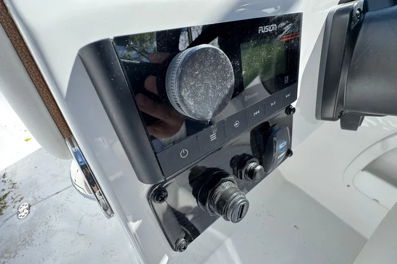 Slide: The Image of 2026 Stingray 211 DC boat dashboard featuring a Fusion audio system with Bluetooth connectivity. - 14