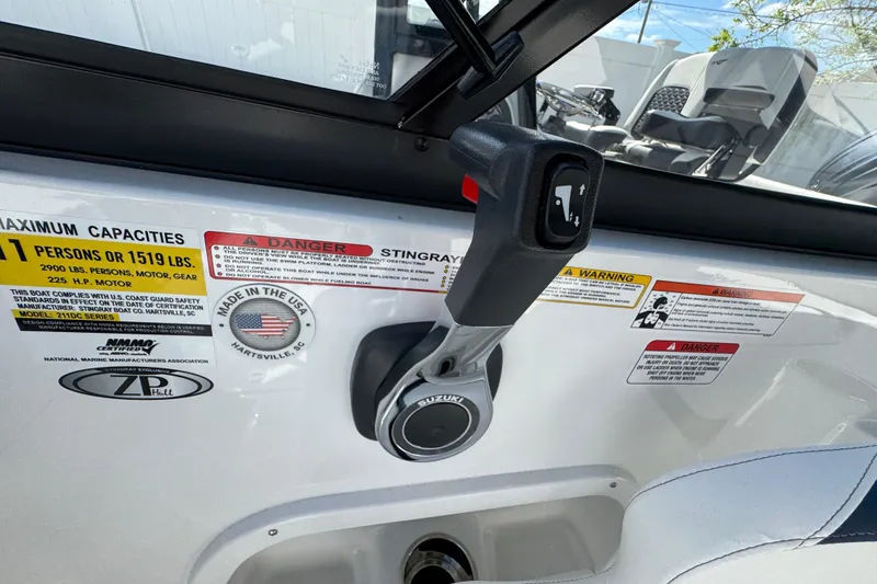 Slide: The Image of Control panel of 2026 Stingray 211 DC boat with capacity and safety labels. - 16