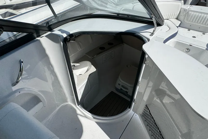 Slide: The Image of 2026 Stingray 211 DC boat interior with compact cabin and seating area. - 19