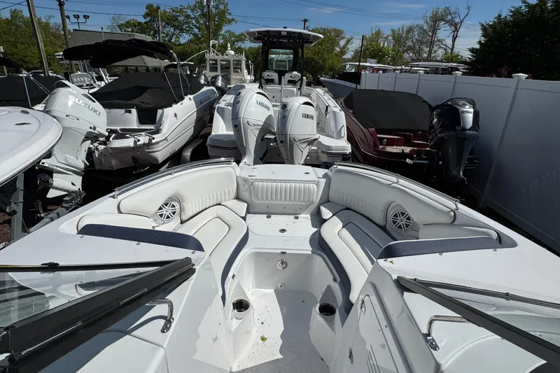 Slide: The Image of 2026 Stingray 211 DC boat with spacious seating and modern design in a showroom. - 21