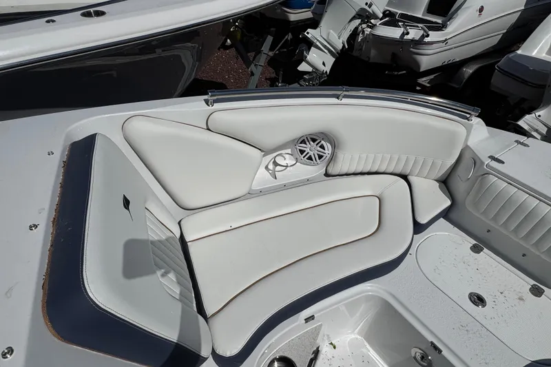 Slide: The Image of 2026 Stingray 211 DC boat interior with white cushioned seating and speaker. - 22