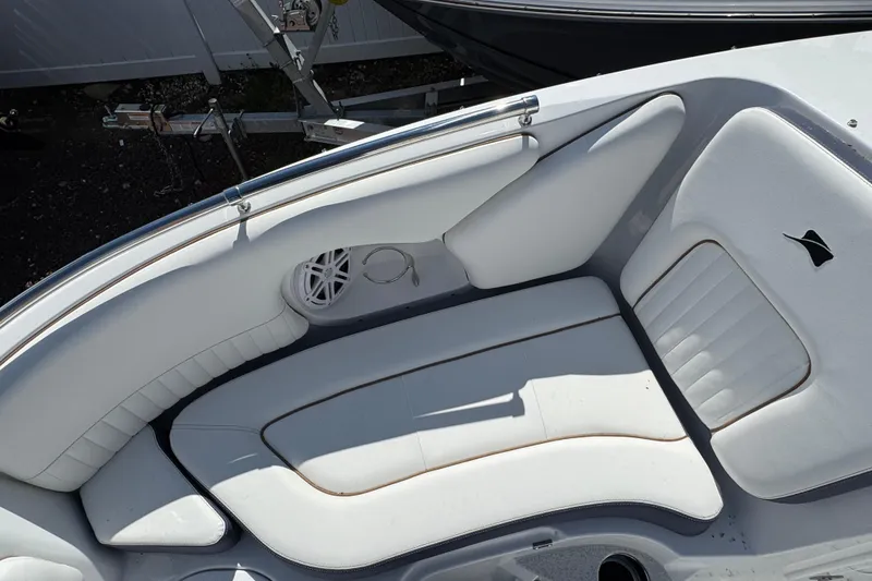 Slide: The Image of 2026 Stingray 211 DC boat interior with white cushioned seating and speaker. - 27