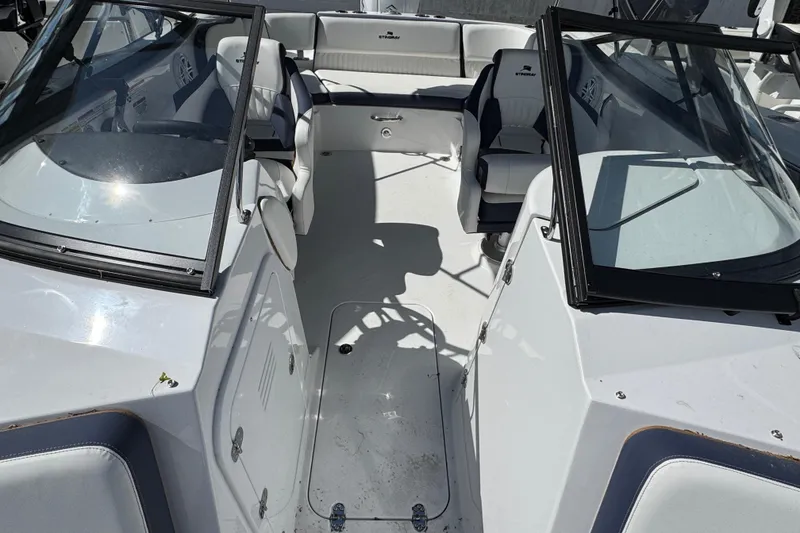 Slide: The Image of 2026 Stingray 211 DC boat interior with seating and windshield, showcasing modern design. - 28