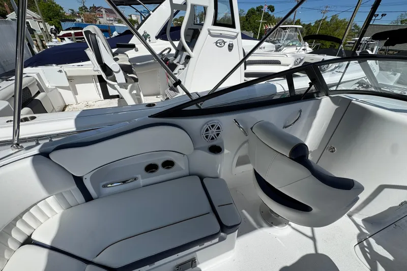 Slide: The Image of 2026 Stingray 211 DC boat interior with sleek seating and modern design features. - 7