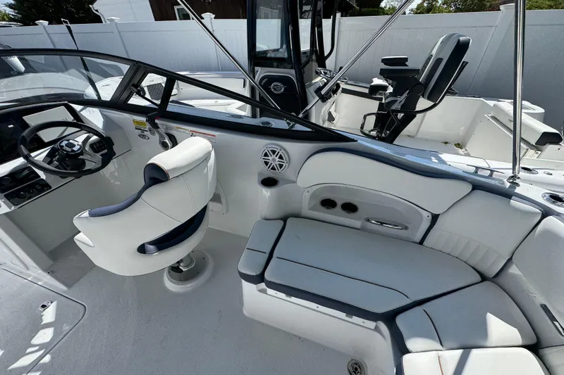 Slide: The Image of 2026 Stingray 211 DC boat interior with white seating and modern dashboard. - 8