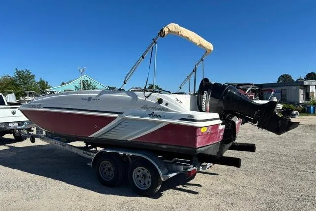 Slide: The Image of 2016 Hurricane SunDeck Sport 188 OB boat on trailer, featuring a red and white design. - 13
