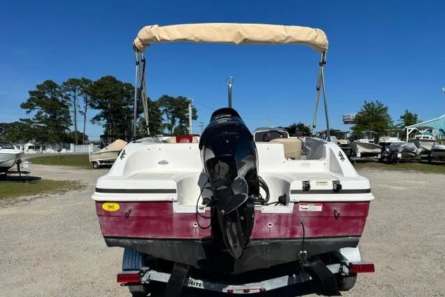 Slide: The Image of 2016 Hurricane SunDeck Sport 188 OB boat with outboard motor and canopy, parked outdoors. - 14