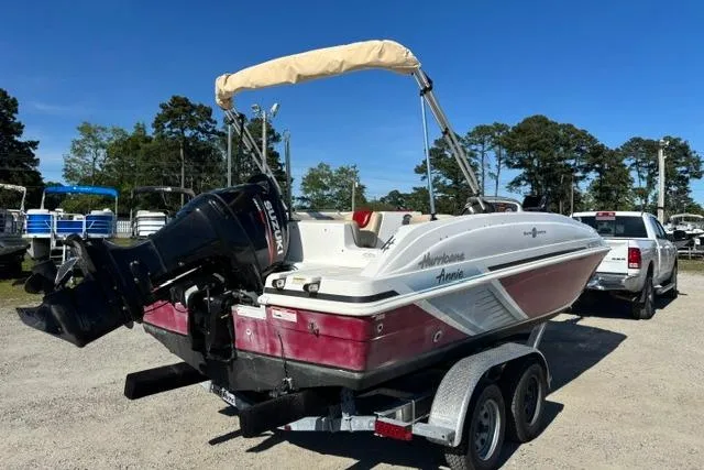 Slide: The Image of 2016 Hurricane SunDeck Sport 188 OB boat on trailer, parked outdoors under clear blue sky. - 15