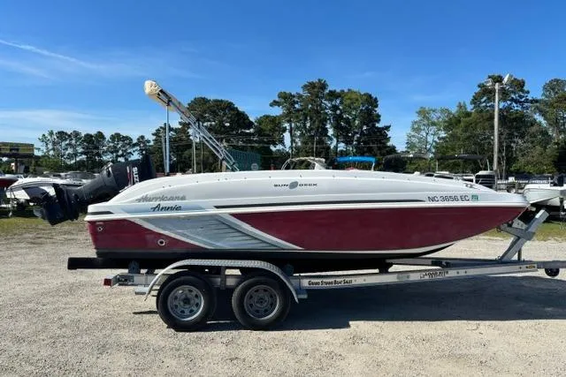 Slide: The Image of 2016 Hurricane SunDeck Sport 188 OB boat on trailer, parked outdoors. - 16