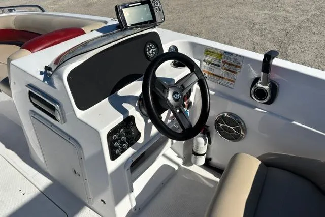 Slide: The Image of 2016 Hurricane SunDeck Sport 188 OB boat dashboard with steering wheel and control panel. - 19