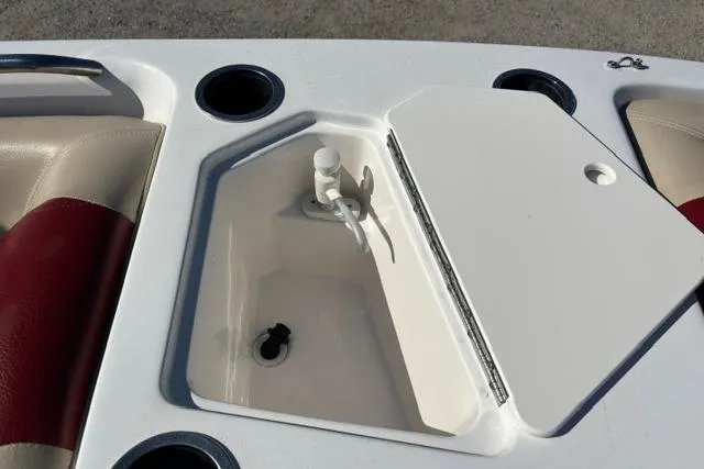Slide: The Image of 2016 Hurricane SunDeck Sport 188 OB boat interior with storage compartment and cup holders. - 24