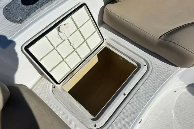 Slide: The Image of Open storage compartment on 2016 Hurricane SunDeck Sport 188 OB boat. - 25