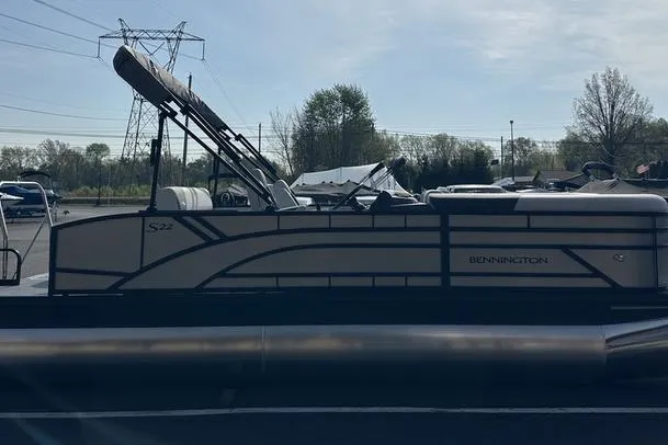 Slide: The Image of 2026 Bennington S Swingback 22 SSB pontoon boat in a parking lot setting. - 11