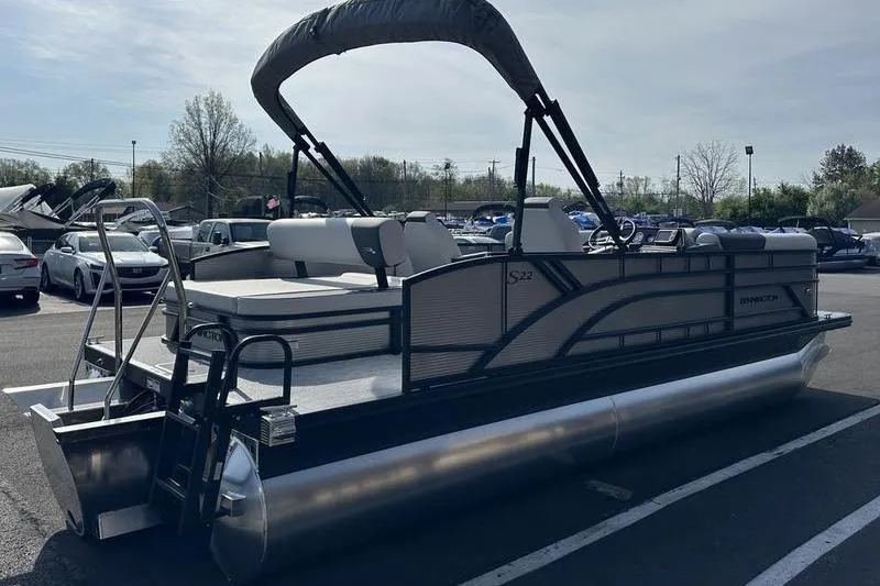 Slide: The Image of 2026 Bennington S Swingback 22 SSB pontoon boat in parking lot, side view. - 12