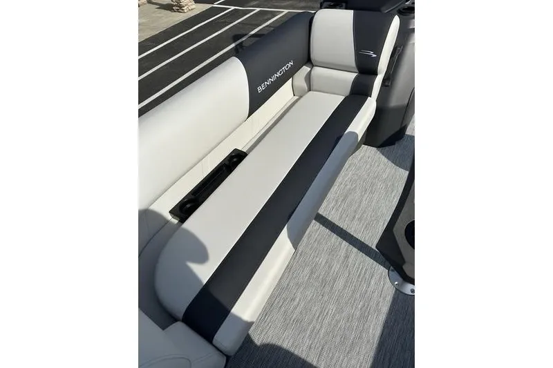 Slide: The Image of 2026 Bennington S Swingback 22 SSB boat seat, featuring sleek black and white upholstery. - 5