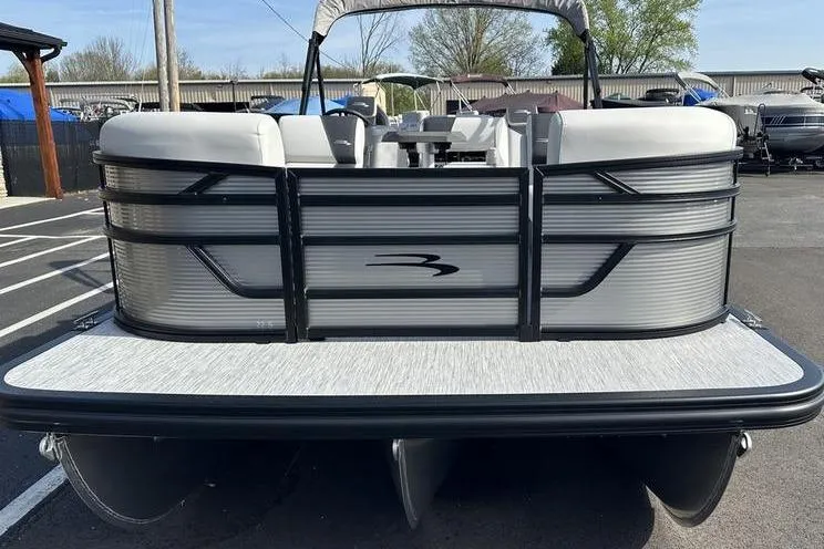 Slide: The Image of 2026 Bennington S Swingback 22 SSB pontoon boat, rear view in a marina setting. - 6