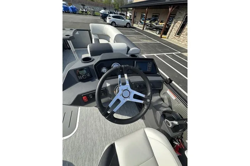 Slide: The Image of 2026 Bennington S Swingback 22 SSB boat dashboard with steering wheel and controls. - 7