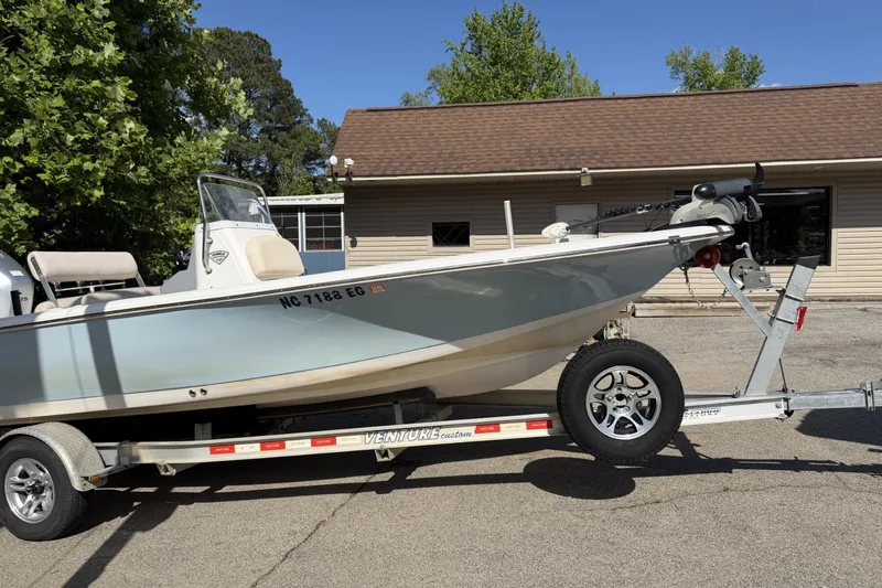 The Image of 2018 Tidewater 1910 Bay Max boat on trailer, parked outdoors near a building. - 0