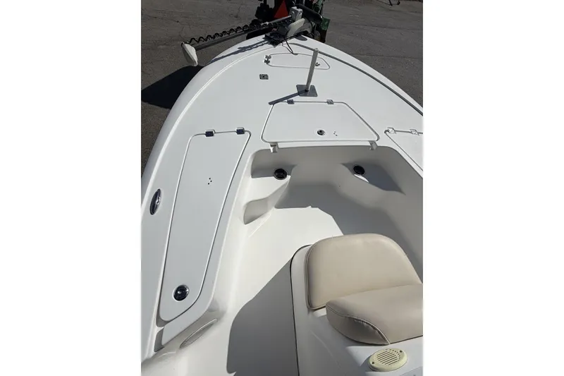 Slide: The Image of 2018 Tidewater 1910 Bay Max boat interior with seating and storage compartments. - 2