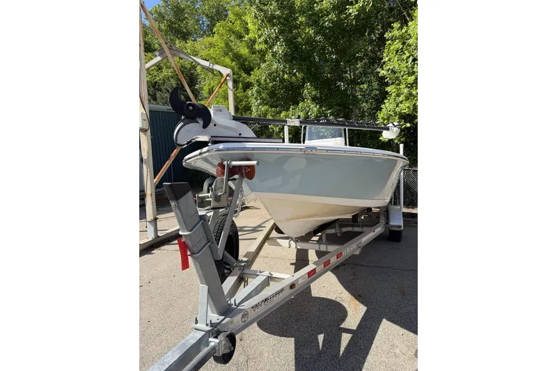 Slide: The Image of 2018 Tidewater 1910 Bay Max boat on trailer, surrounded by trees. - 3