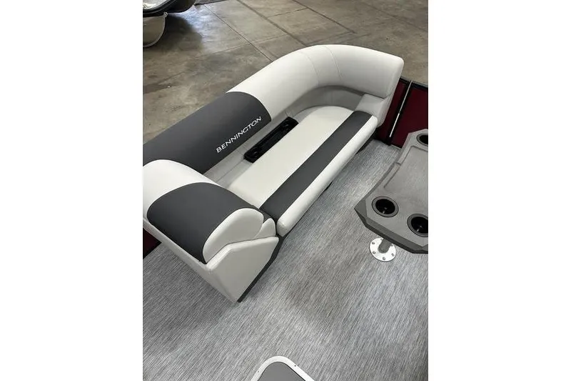 Slide: The Image of 2026 Bennington S Swingback 22 SSB boat interior with gray seating and cup holders. - 10