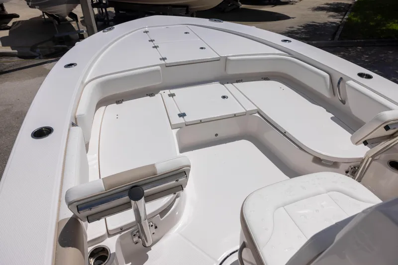 Slide: The Image of 2025 Robalo 246 Cayman boat interior with spacious seating and storage compartments. - 11