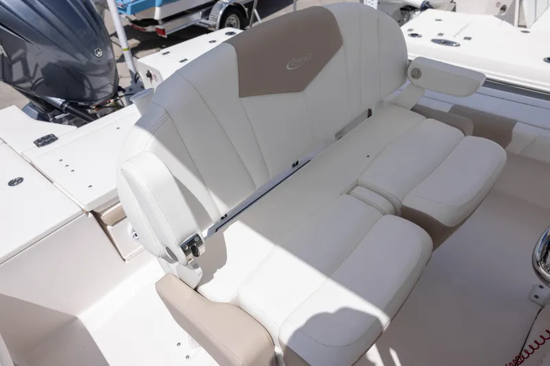 Slide: The Image of 2025 Robalo 246 Cayman boat seating with white and beige upholstery. - 5