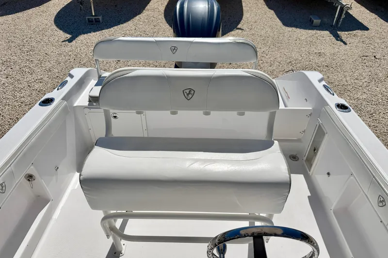 Slide: The Image of 2022 Century 2301 Center Console boat interior with white seating and steering wheel. - 13
