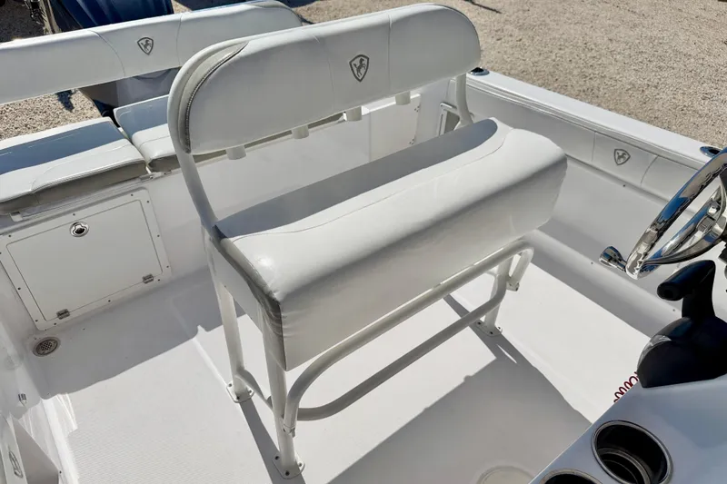 Slide: The Image of 2022 Century 2301 Center Console boat interior with white seating and steering wheel. - 14