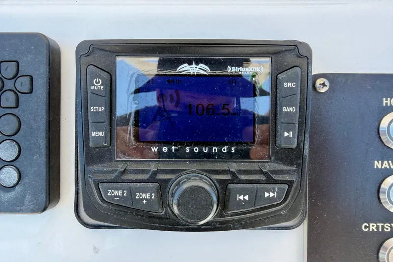 Slide: The Image of Wet Sounds audio system on 2022 Century 2301 Center Console, tuned to 106.5 FM. - 20