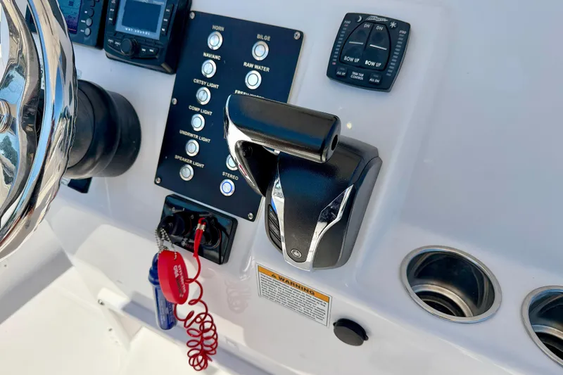 Slide: The Image of Century 2301 Center Console 2022 boat dashboard with controls and steering wheel. - 21