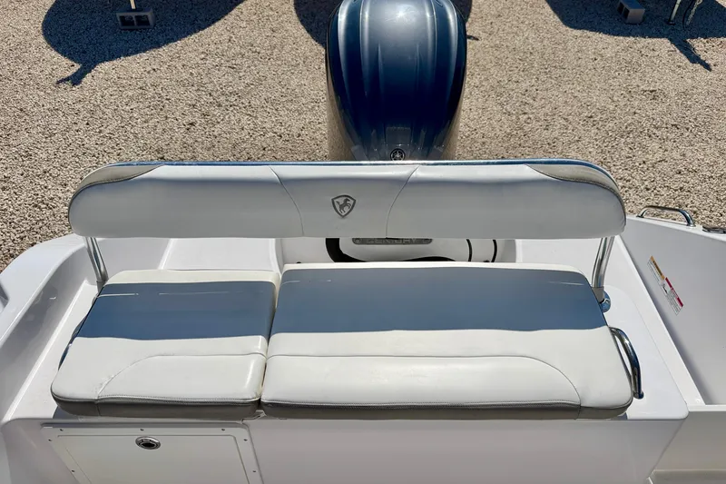 Slide: The Image of 2022 Century 2301 Center Console boat seating with engine in background. - 25