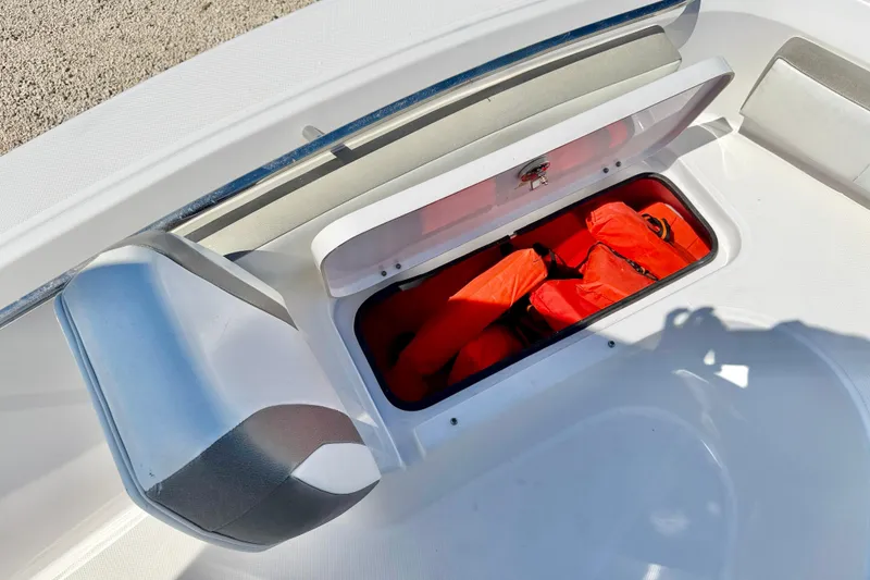 Slide: The Image of Storage compartment with life jackets on a 2022 Century 2301 Center Console boat. - 31